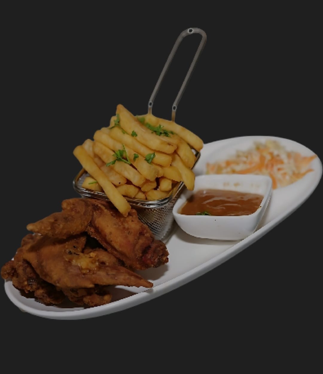 Fried chicken wings with a basket of fries, coleslaw and dipping sauce