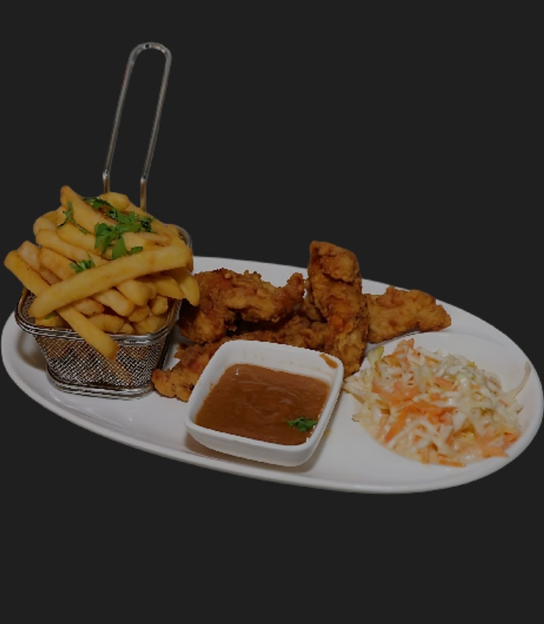 Crispy fried chicken pieces with fries, coleslaw and dipping sauce